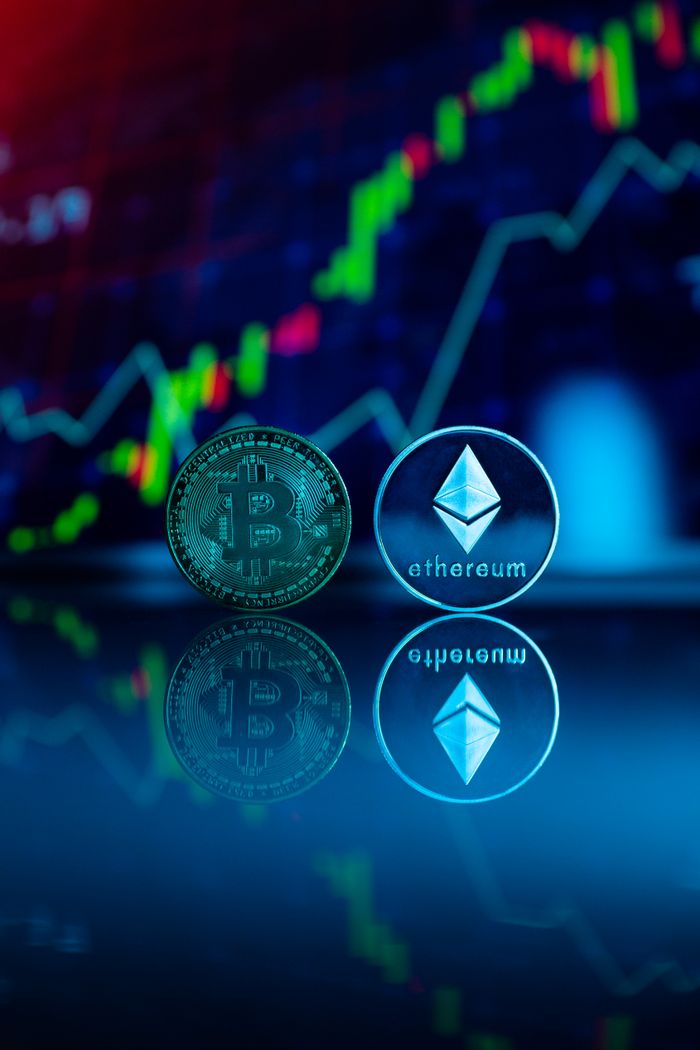 about-us Conceptual image of Bitcoin and Ethereum coins reflecting stock market graph for cryptocurrency trading.