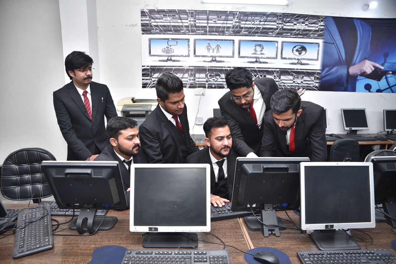services-bg Group of professionals collaborating on computer work in a modern office.